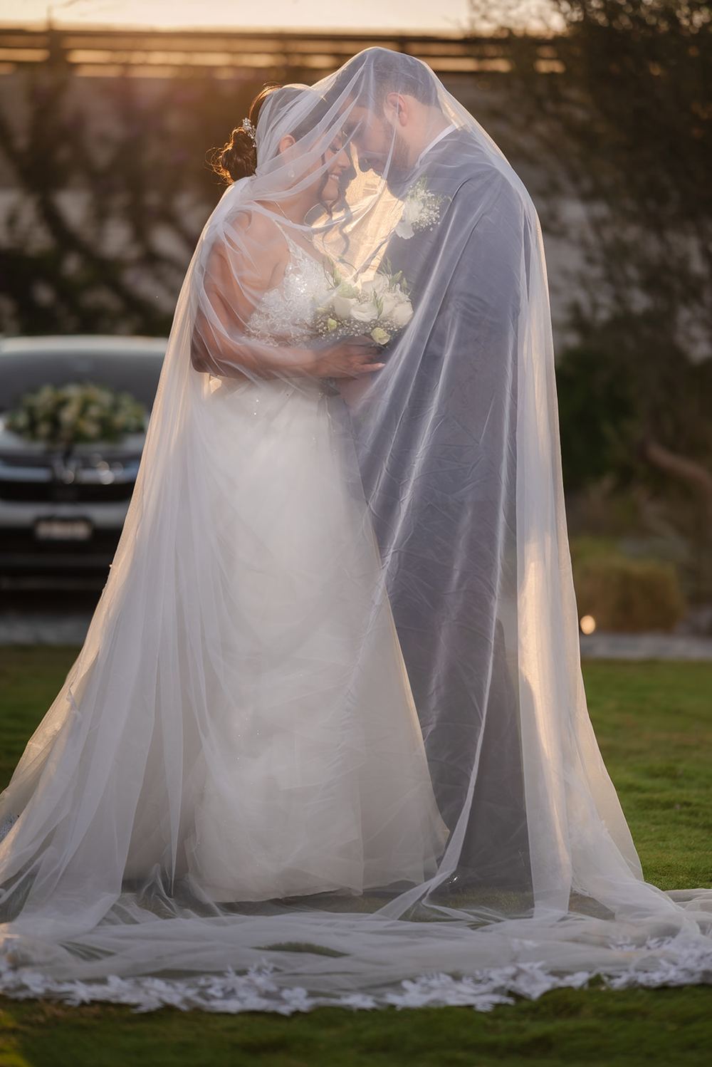 Novios bajo el velo al atardecer, David Roche Photography